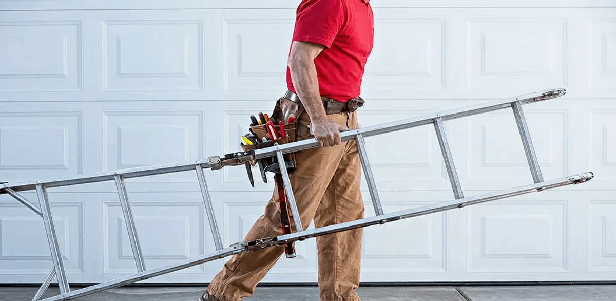 Garage door repair technician arriving with tools and ladder in Duluth, MN