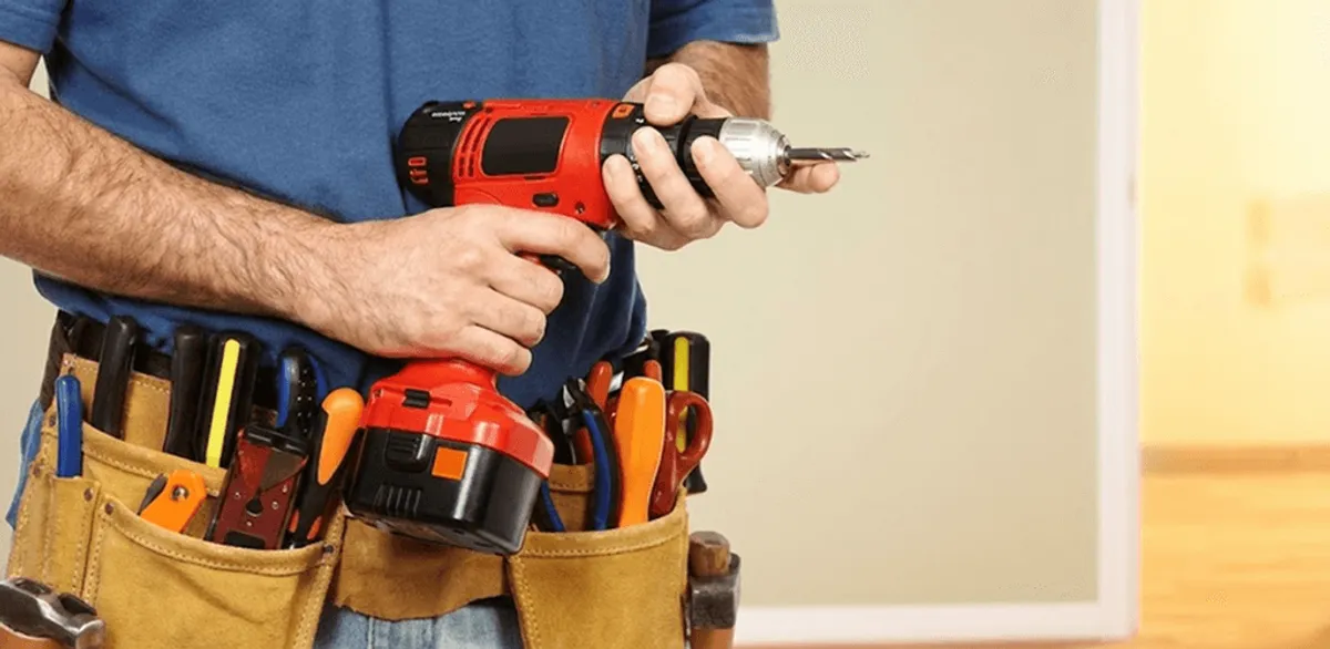 Handyman holding a power drill for home repairs and installations in Duluth, MN